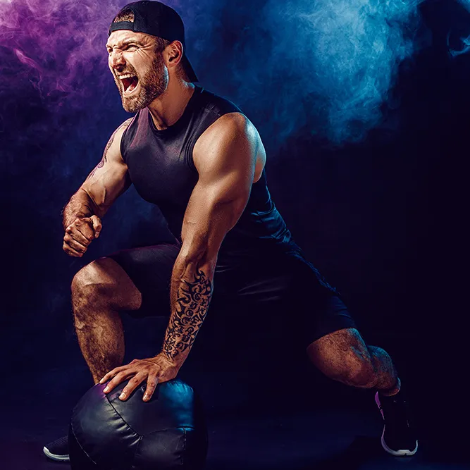 aggressive-bearded-muscular-sportsman-is-working-out-push-up-with-medicine-ball-isolated-dark-wall-with-smoke